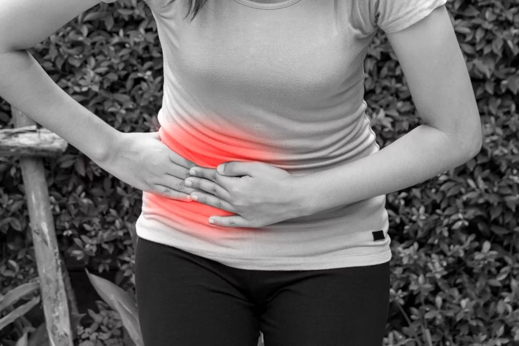 Woman touching her own belly with stomachache, appendicitis pain